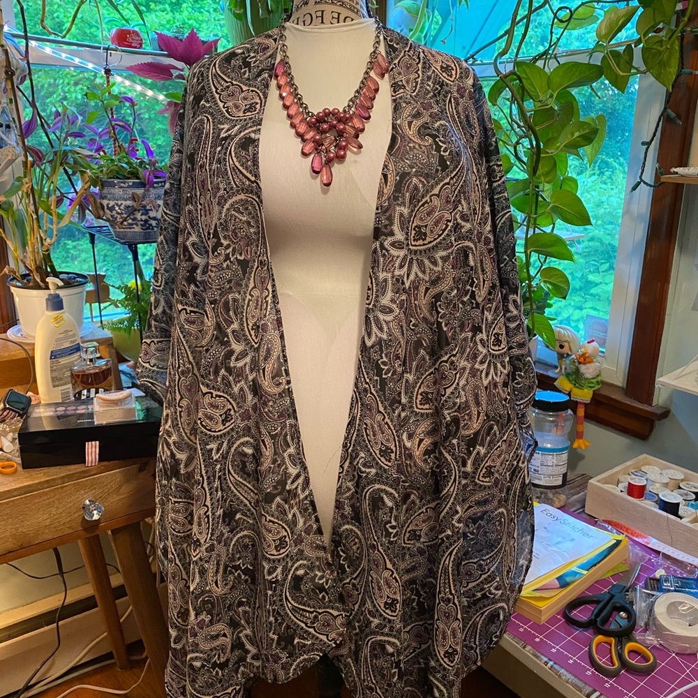 Tunic, one size fits all.  Light fabric with purple, gray, black and pink tones.